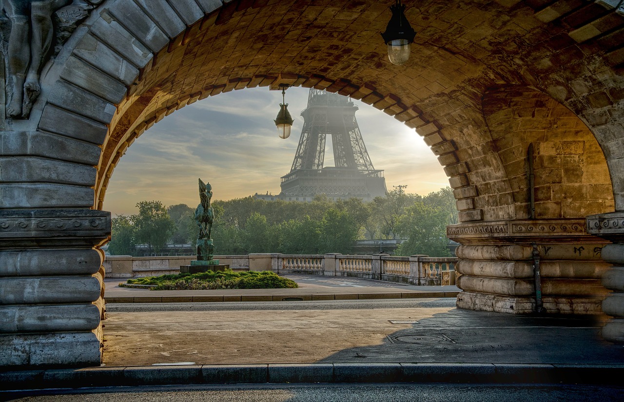 The Eiffel Tower viewed through an archway at sunrise in Paris, France