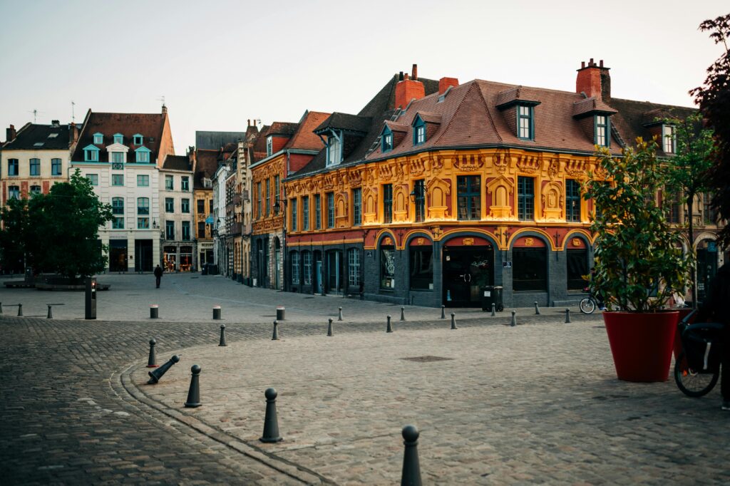 Colorful historic buildings in the Grand Place of Lille, France, at sunrise. Lille travel guide