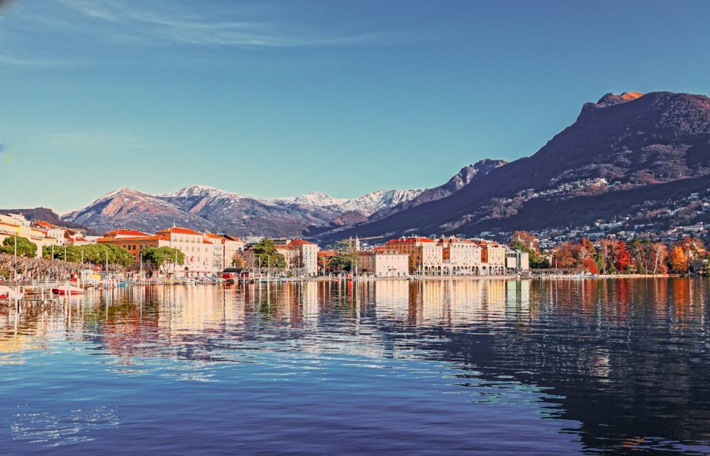 A picturesque view of Lake Geneva with the city of Geneva nestled along its shores and the snow-capped Alps in the background, showcasing the beauty of Switzerland’s second-largest city.